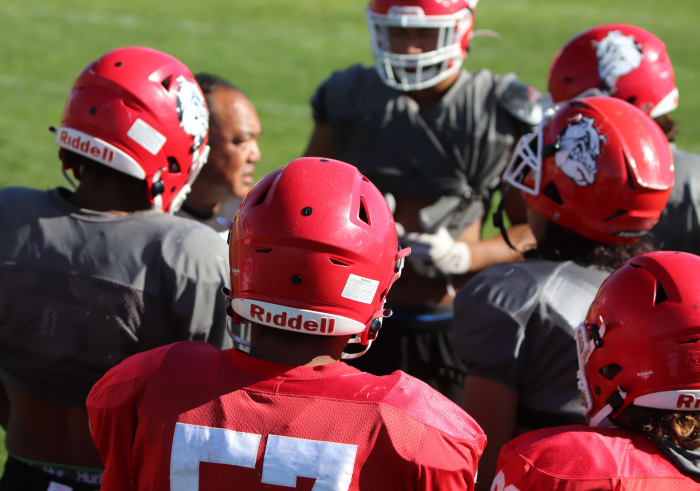 Oak Hills' players listen in on what coach Rick Mitsuda has to say.